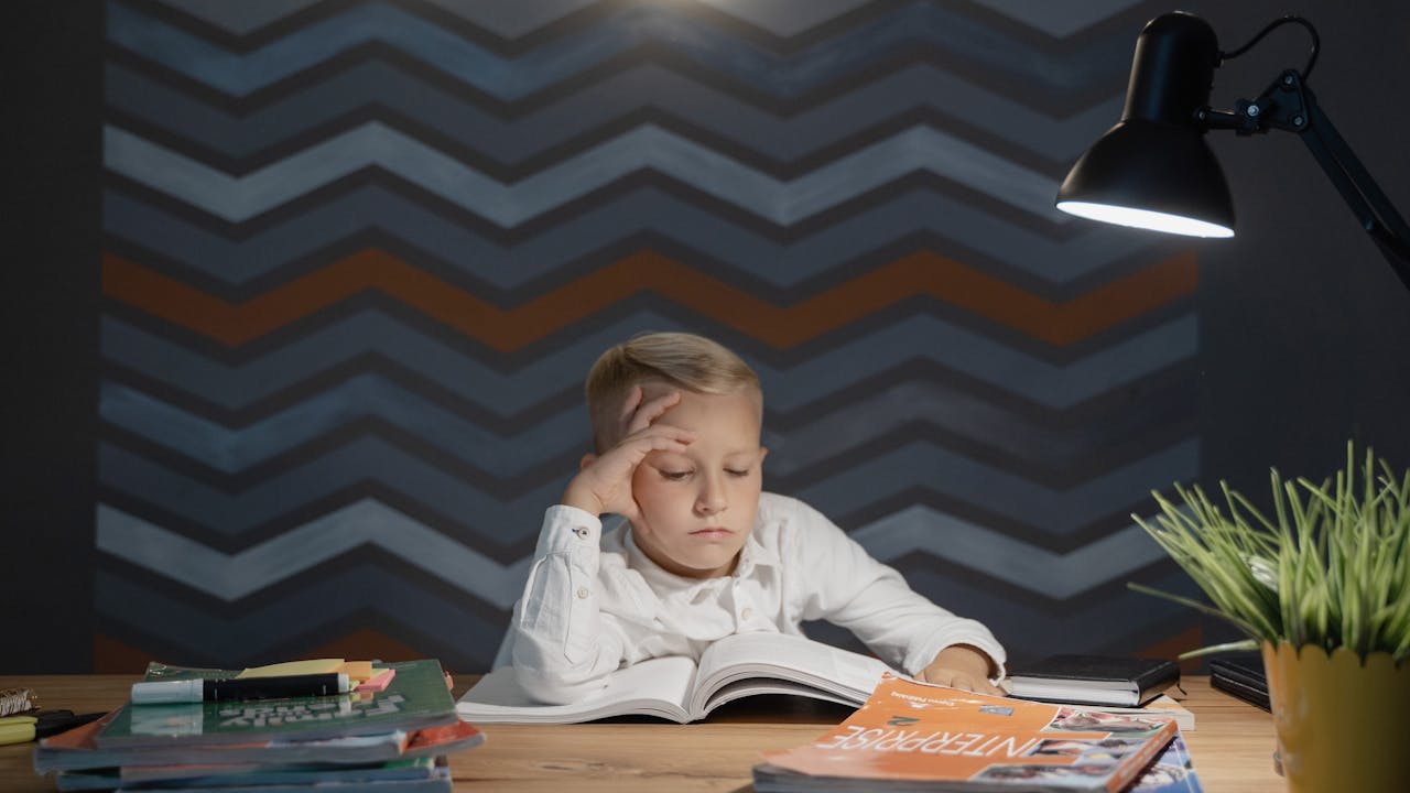 Student studying late at night with desk lamp
