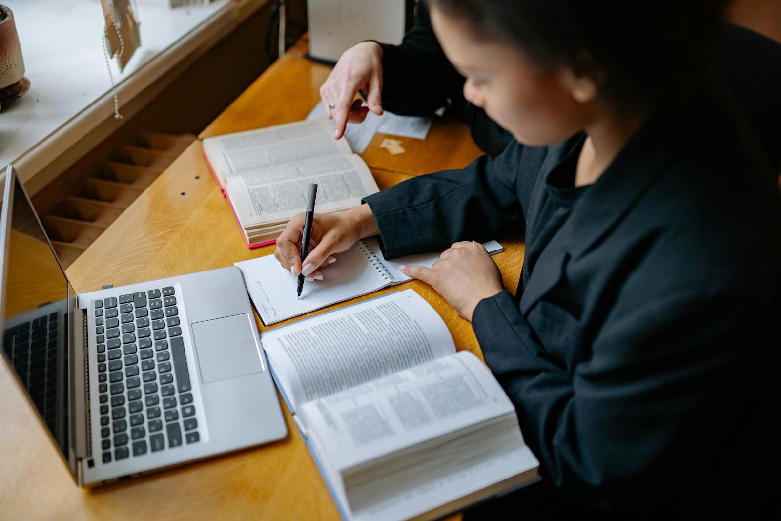 Student practicing oral exam with notes