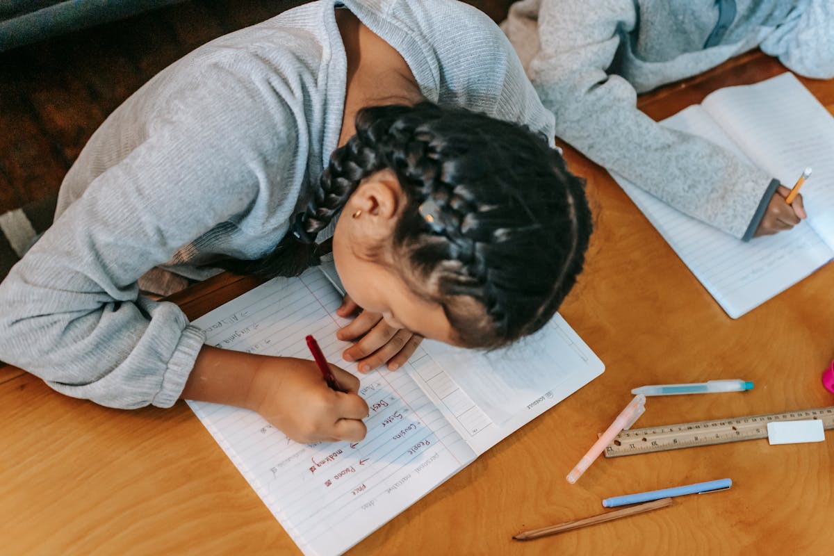 Student writing flashcards at a desk